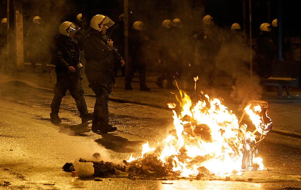 Riot police operate during clashes in the Athens neighborhood of Exarchia, a haven for extreme leftists and anarchists late. The minor clashes broke out after an anti-government protest against Greece's four-month bailout extension agreement with European Union.