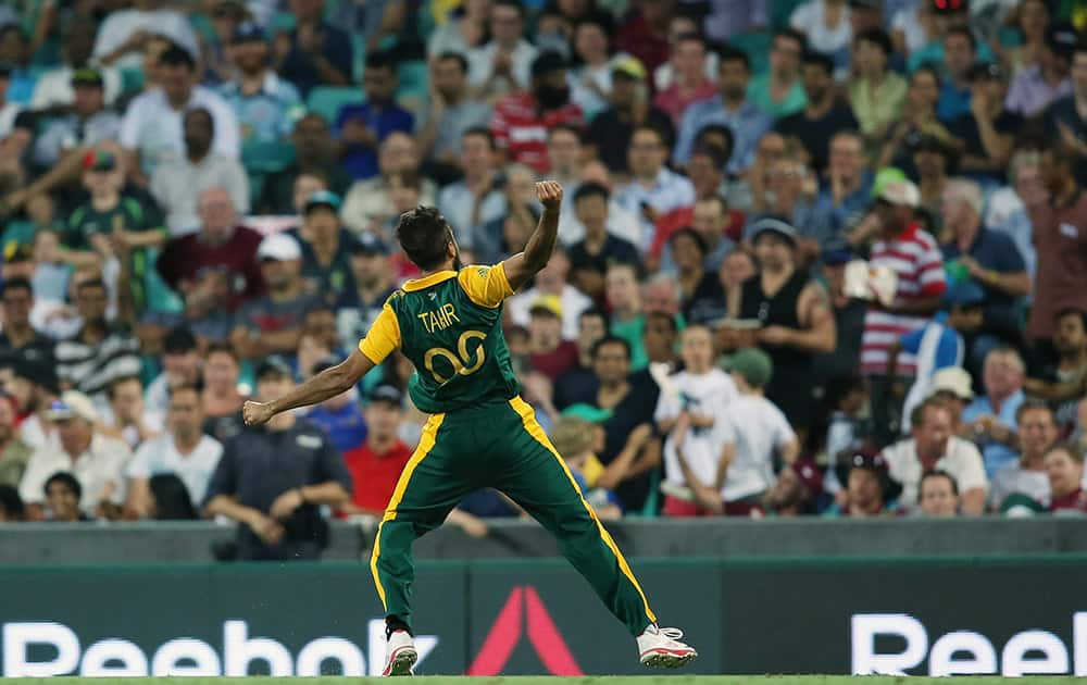 South Africa's Muhammad Imran Tahir celebrates to the crowd after taking the wicket of West Indies Lendl Simmons during their Cricket World Cup Pool B match in Sydney, Australia.