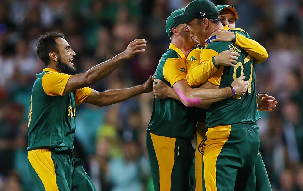 South Africa's Kyle Abbott is congratulated by teammates after taking a catch to dismiss West Indies Andre Russell for no score during their Cricket World Cup Pool B match in Sydney, Australia.