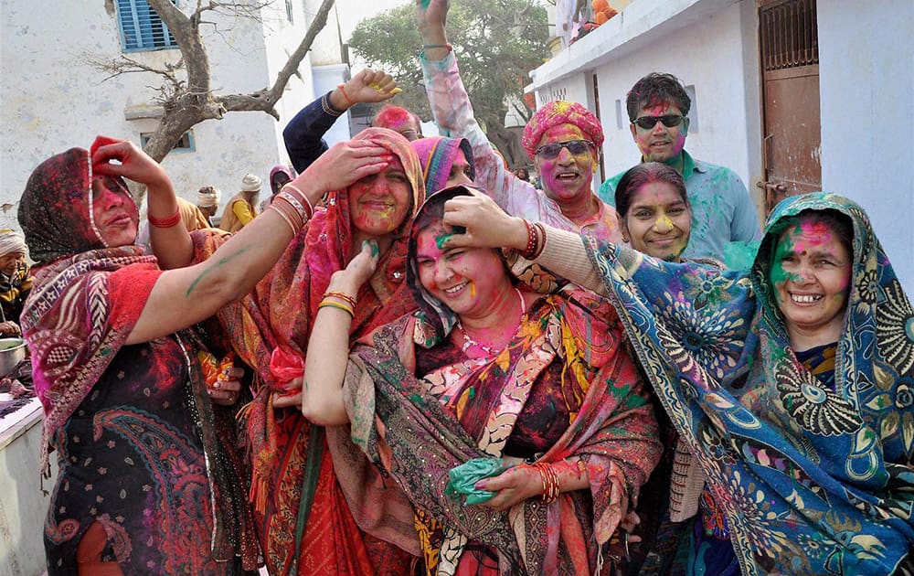 Devotees during Holi celebration in Barsana near Mathura .