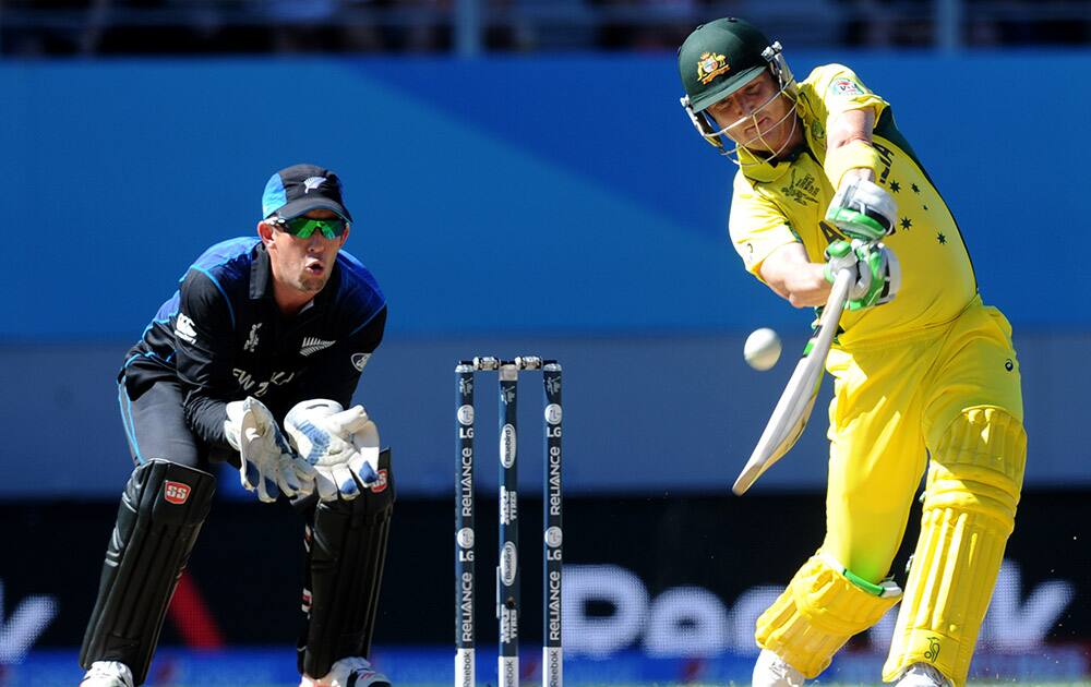 Australia's Mitchell Starc, right, is congratulated by his teammate Patrick Cummins after dismissing New Zealand batsman Martin Guptill, left, during their Cricket World Cup match in Auckland, New Zealand.