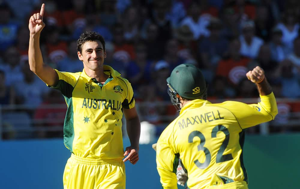 Australia's Mitchell Starc celebrates with teammate Glenn Maxwell after taking the wicket of New Zealand’s Ross Taylor during their Cricket World Cup match in Auckland, New Zealand.