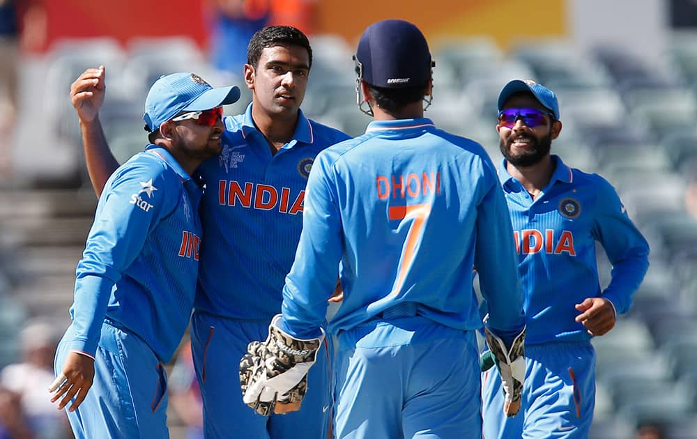 R Ashwin, celebrates with team mates Suresh Raina, captain M S Dhoni and Rohit Sharma, after taking the wicket of United Arab Emirates K. Karate during their Cricket World Cup Pool B match in Perth, Australia