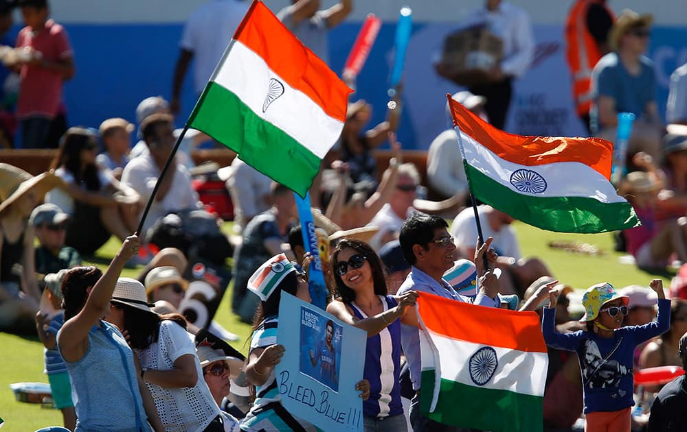 Fan celebrate after the wicket of United Arab Emirates K. Karate fell during their Cricket World Cup Pool B match in Perth, Australia.