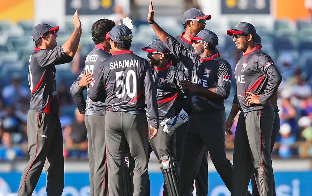 United Arab Emirates team celebrates taking the wicket of India's Shikhar Dhawan during their Cricket World Cup Pool B match in Perth, Australia.