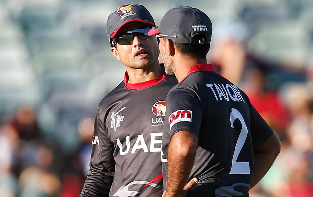 United Arab Emirates Shaiman Anwar left, speaks to Mohamed Tauqir during their Cricket World Cup Pool B match against India in Perth, Australia.