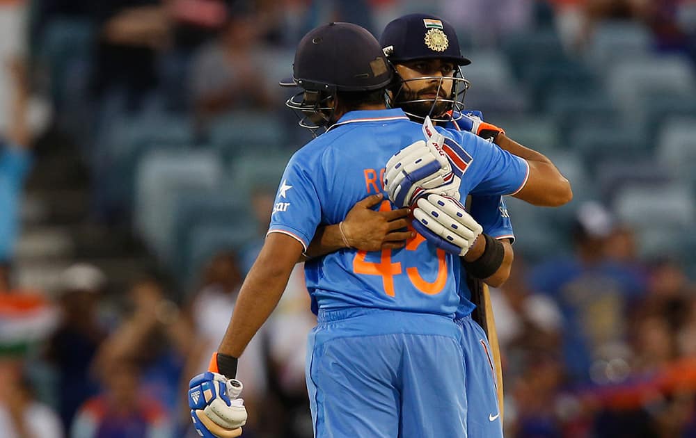 Virat Kohli and Rohit Sharma embrace after they won their Cricket World Cup Pool B match against the United Arab Emirates in Perth, Australia.