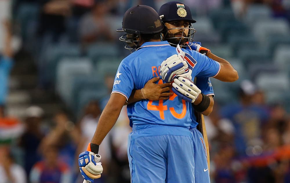 Virat Kohli and Rohit Sharma embrace after they won their Cricket World Cup Pool B match against the United Arab Emirates in Perth, Australia.