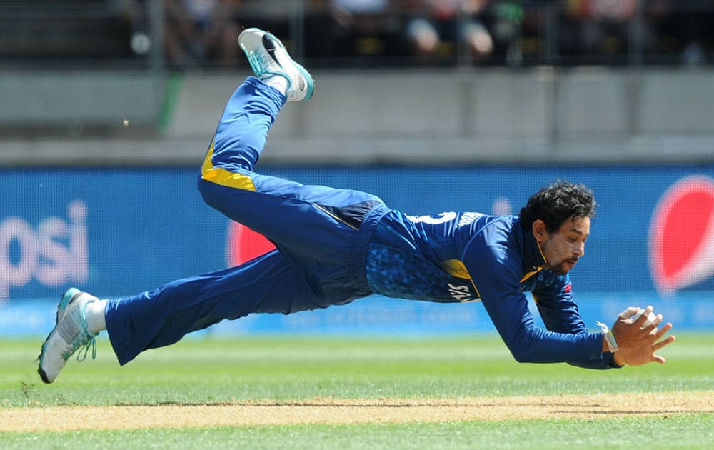 Sri Lankan bowler T.M.Dislshan takes a catch to dismiss England's Gary Balance during their Cricket World Cup match in Wellington, New Zealand.