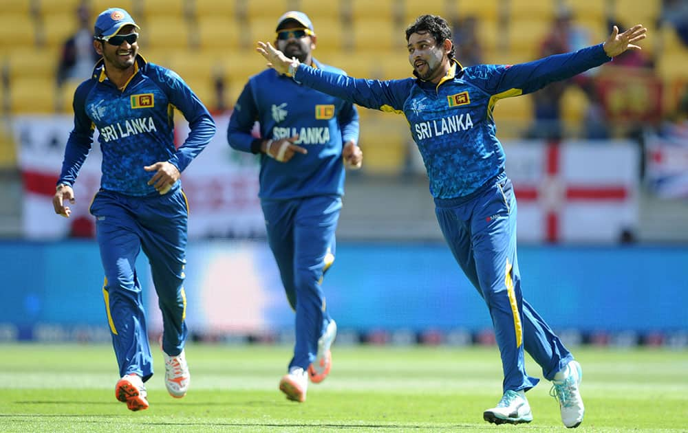 Sri Lankan bowler T.M.Dislshan, right, celebrates after taking a catch to dismiss England's Gary Balance during their Cricket World Cup match in Wellington, New Zealand.