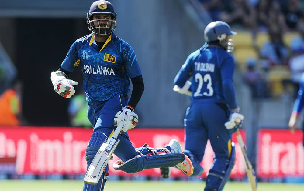 Sri Lanka's Lahiru Thirimanne, left, runs with batting partner Sri Lanka's Tillakaratne Dilshan during their Cricket World Cup match against England in Wellington, New Zealand.