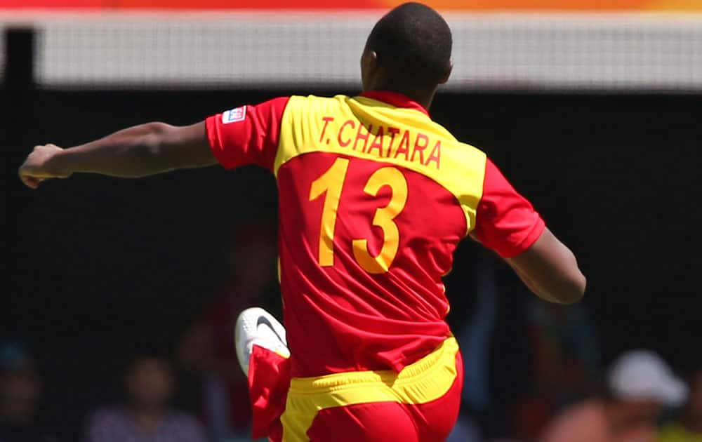 Zimbabwean Tendai Chatara celebrates the wicket of Pakistan's Ahmed Shehzad during the Pool B Cricket World Cup match in Brisbane, Australia.