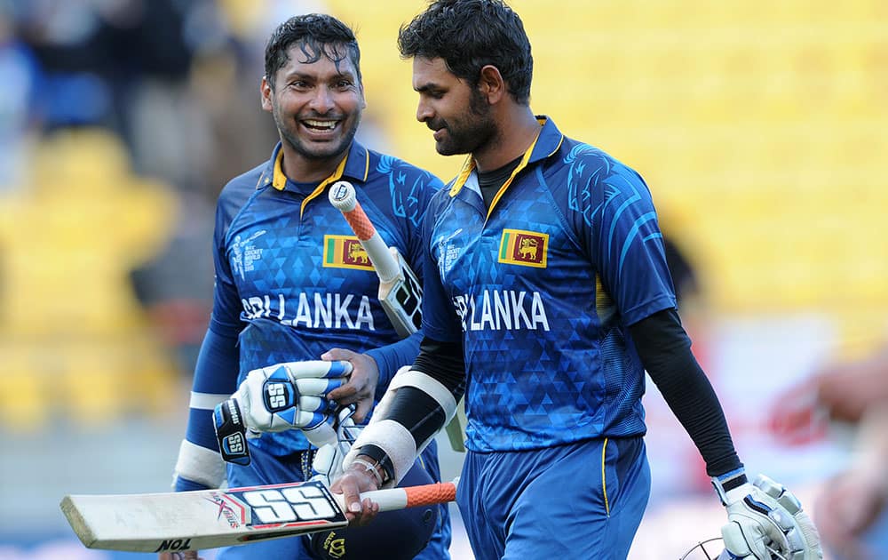 Sri Lanka's Kumar Sangakkara, left, walks from the field with teammate Lahiru Thirimanne after they defeated England by nine wickets during their Cricket World Cup match in Wellington, New Zealand.