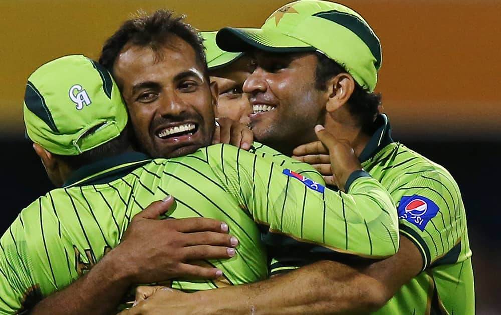 Pakistan's Wahab Riaz, center, celebrates the wicket of Zimbabwe's Craig Ervine during their Pool B Cricket World Cup match in Brisbane, Australia.