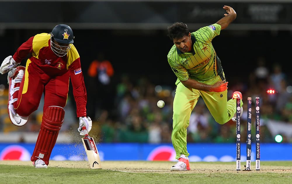 Zimbabwe’s Tinashe Panyangara, left, successfully reaches the crease foiling a run out attempt by Pakistan’s Sohail Khan during their Pool B Cricket World Cup match in Brisbane, Australia.