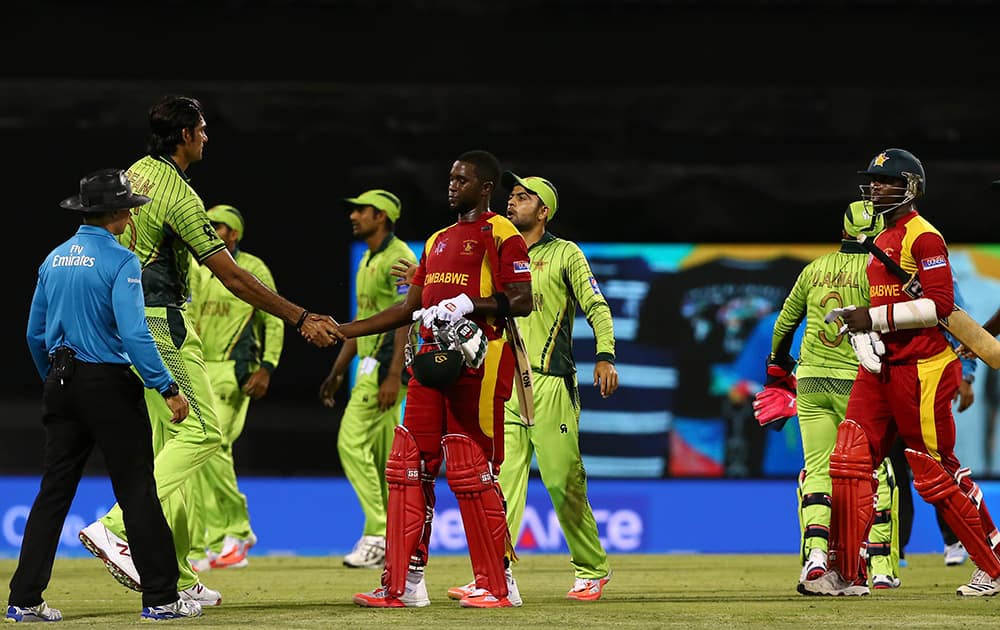 Pakistan's Mohammad Irfan, left, shakes hands with Zimbabwean batsmen after Pakistan won in the Pool B Cricket World Cup match in Brisbane, Australia.