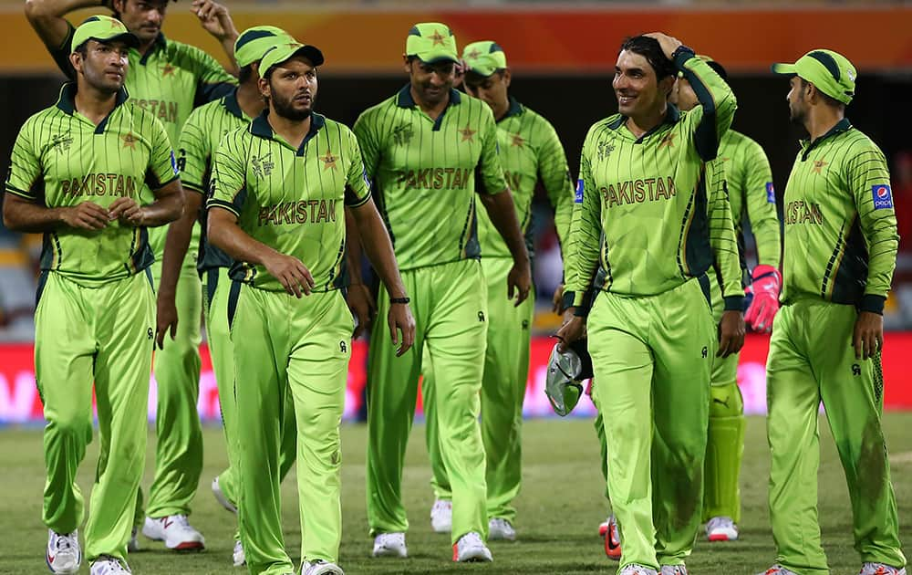 Pakistan's players led by skipper Misbah-ul-Haq, second right, walk back after defeating Zimbabwe in the Pool B Cricket World Cup match in Brisbane, Australia.