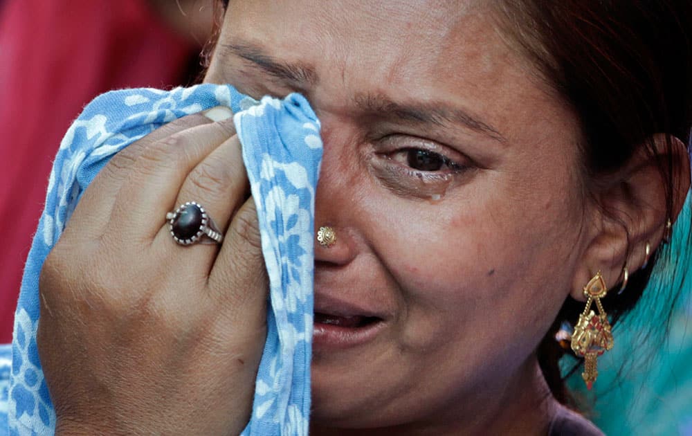 A riot victim wipes her tears during a ceremony marking the anniversary of India`s 2002 anti-Muslim riots, that left more than 1,000 dead, in Ahmadabad.