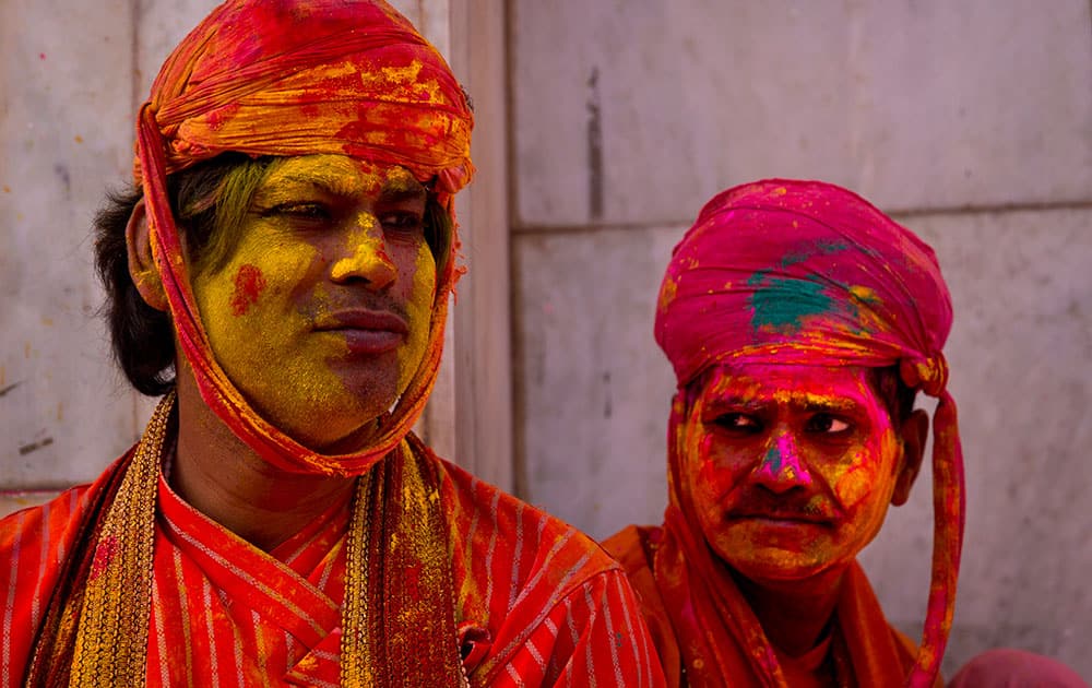 Villagers from Nandgaon wait for the arrival of villagers from Barsana at the Nandagram temple, famous for Lord Krishna and his brother Balram, during Lathmar holi festival, in Nandgaon.