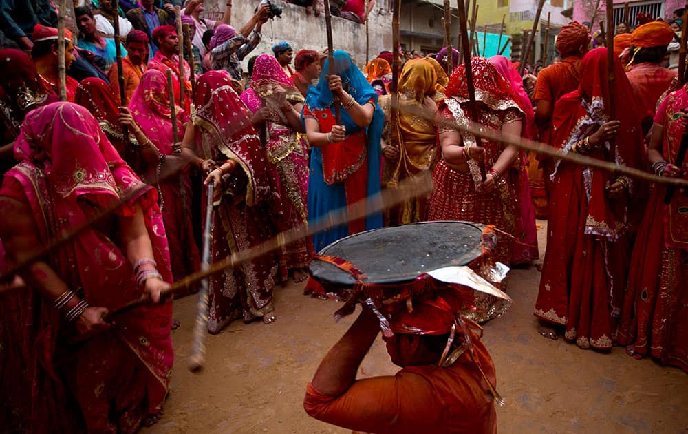 Women from Nandgaon village beat the shield of a man from Barsana during Lathmar festival celebrations in Nandgaon.