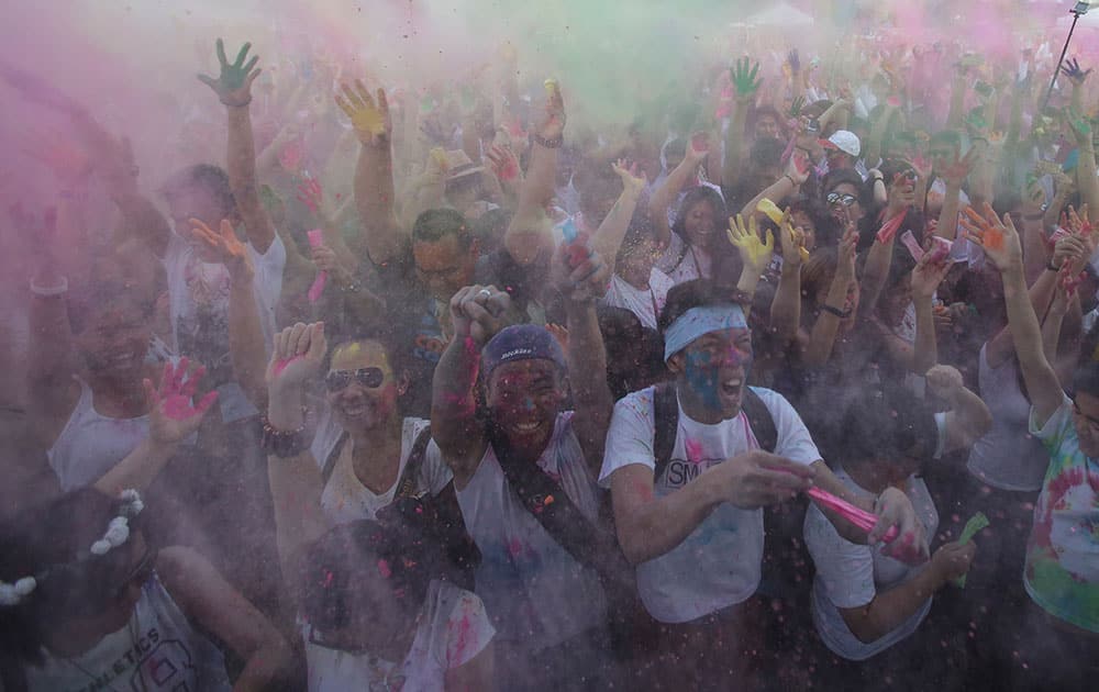 Participants throw colored powder in the air as they join celebrations of the Holi festival in suburban Pasay, south of Manila.