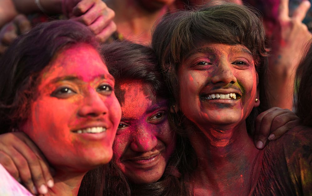 Indian nationals with colored powder on their face join celebrations of the Holi festival in suburban Pasay, south of Manila.