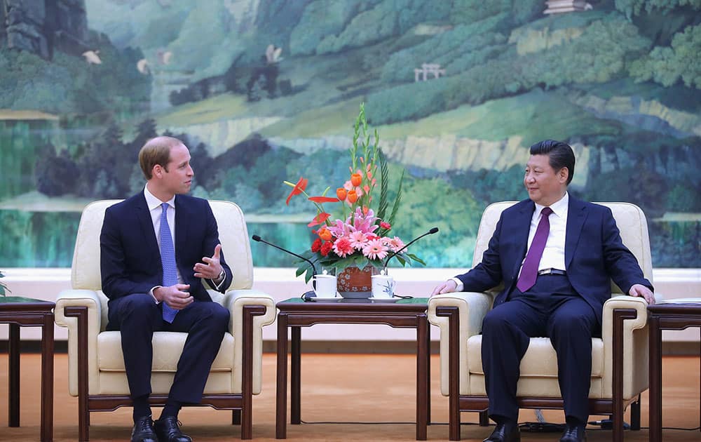 Britain's Prince William, left, meets Chinese President Xi Jinping at the Great Hall of the People in Beijing.