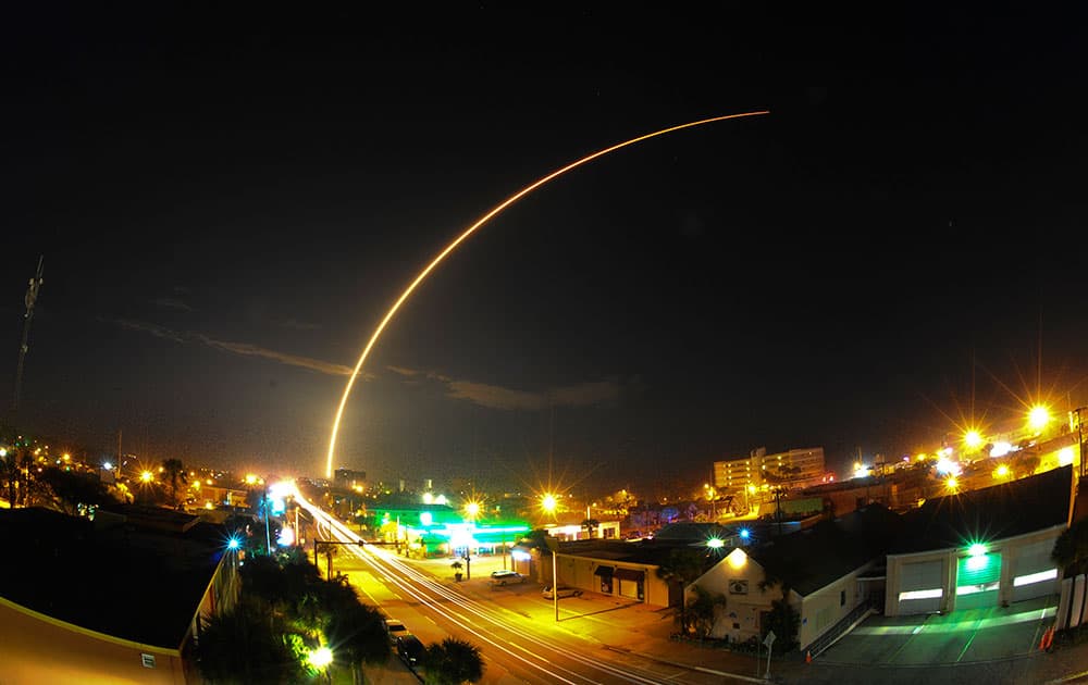 SpaceX Falcon9 rocket carrying two commercial communications satellites launched from Cape Canaveral Air Force Station Launch Complex 41, as seen over the skyline of downtown Cocoa Beach.