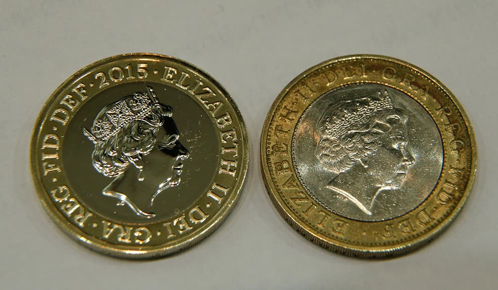 A new 2 pound coin (US$ 3.08), left is photographed next to a current 2 pound coin as a new portrait of Britain's Queen Elizabeth II is unveiled at the National Portrait Gallery in London. The image Britain's Queen Elizabeth II, the fifth of her reign was made by Jody Clark, at 33 the youngest designer. Portraits of the Queen were made in 1952,1968,1985,1998 and 2015, the image will appear on coins later this year.