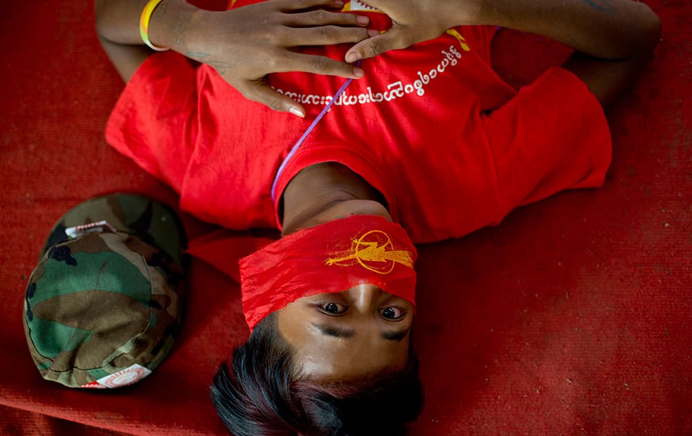 A student protester lies on a monastery floor after police surrounded the monastery apparently to prevent them from proceeding with a protest march to Yangon from Letpadan, north of Yangon, Myanmar.