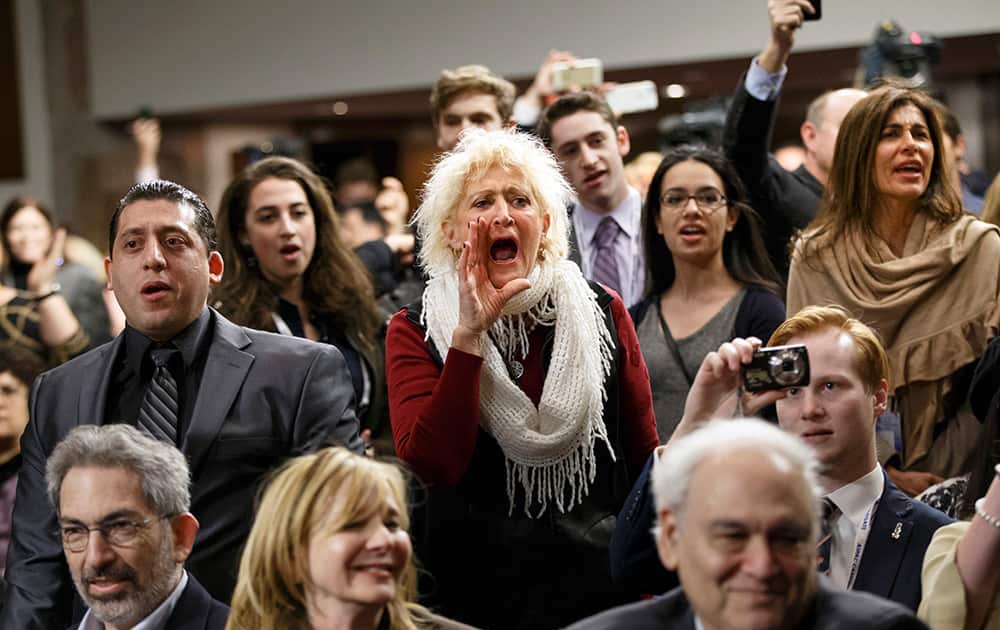 Audience members shout back at demonstrators with the activist group Codepink as they disrupt an event hosted by an organization fighting discrimination against Jews just before a panel discussion with Holocaust survivor Elie Weisel and Sen. Ted Cruz, R-Texas, on Capitol Hill in Washington.
