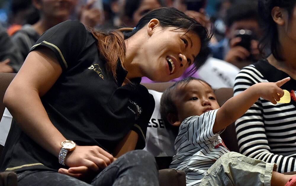 Boxer Mary Kom with her son at a promotional event for Box Out, a social campaign against eve teasing, at IIT in New Delhi.