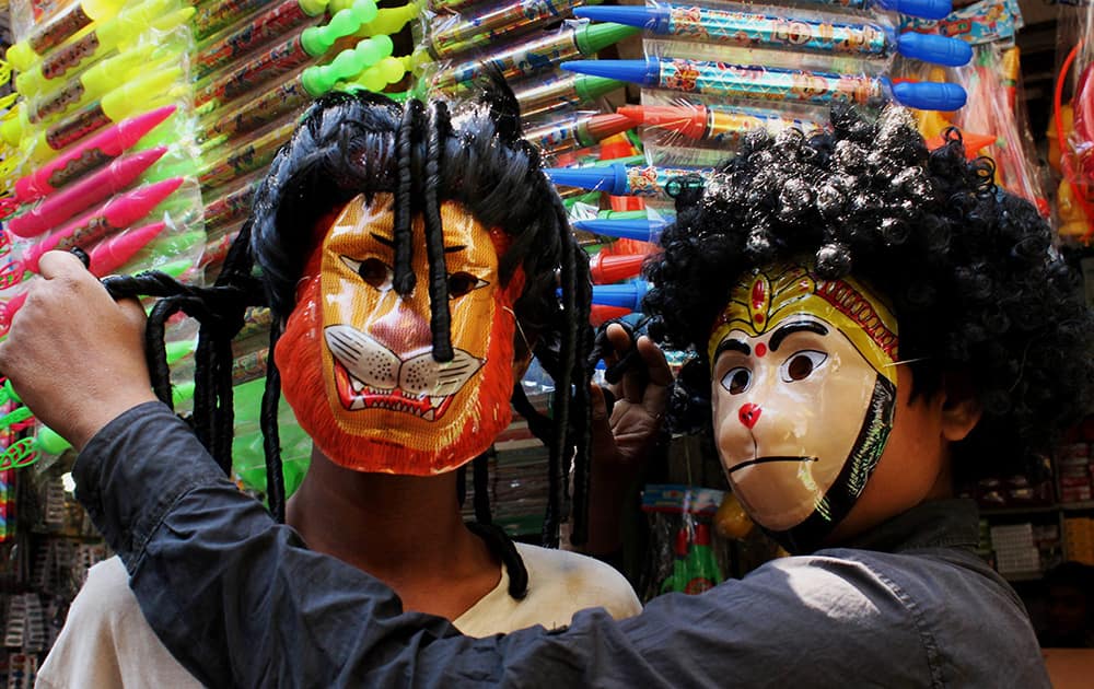 Vendors display wigs showing the hairstyles of West Indies batsman Chris Gayle and Sri Lankan bowler Lasita Malinga ahead of the Holi festival, in Nagpur.