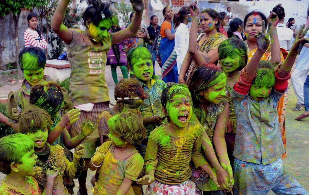 Children play with colours ahead of Holi festival at an orphanage in Lucknow.