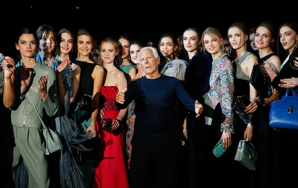 Italian fashion designer Giorgio Armani, center, poses with his models after presenting the Giorgio Armani women's Fall-Winter 2015-2016 collection, part of Milan Fashion Week