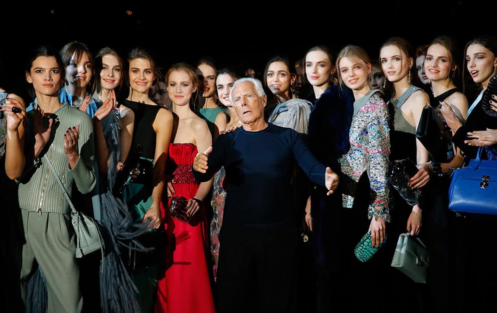 Italian fashion designer Giorgio Armani, center, poses with his models after presenting the Giorgio Armani women's Fall-Winter 2015-2016 collection, part of Milan Fashion Week.