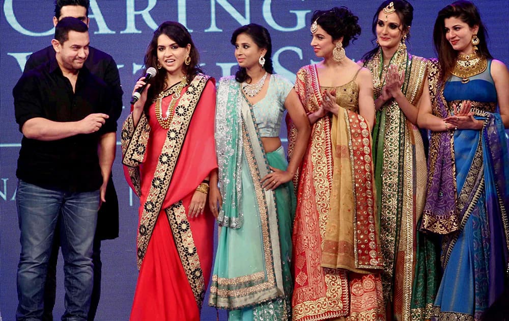 Bollywood actor Aamir Khan with designer Shaina NC and models walks the ramp during a fashion show to raise funds to support children suffering from blood cancer, in Mumbai. -dna