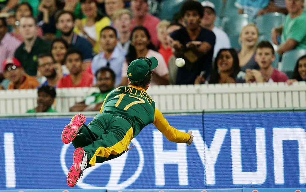 South Africa's AB De Villiers is airborne as he attempts to take a catch during their Cricket World Cup Pool B match against Ireland in Canberra, Australia.