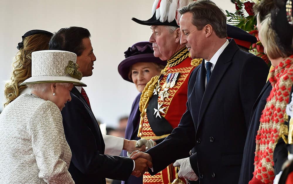 Mexico's President Enrique Pena Nieto stands with Queen Elizabeth, as he is welcomed by Britain's Prime Minister David Cameron, during a ceremonial welcome at Horse Guards Parade in London.