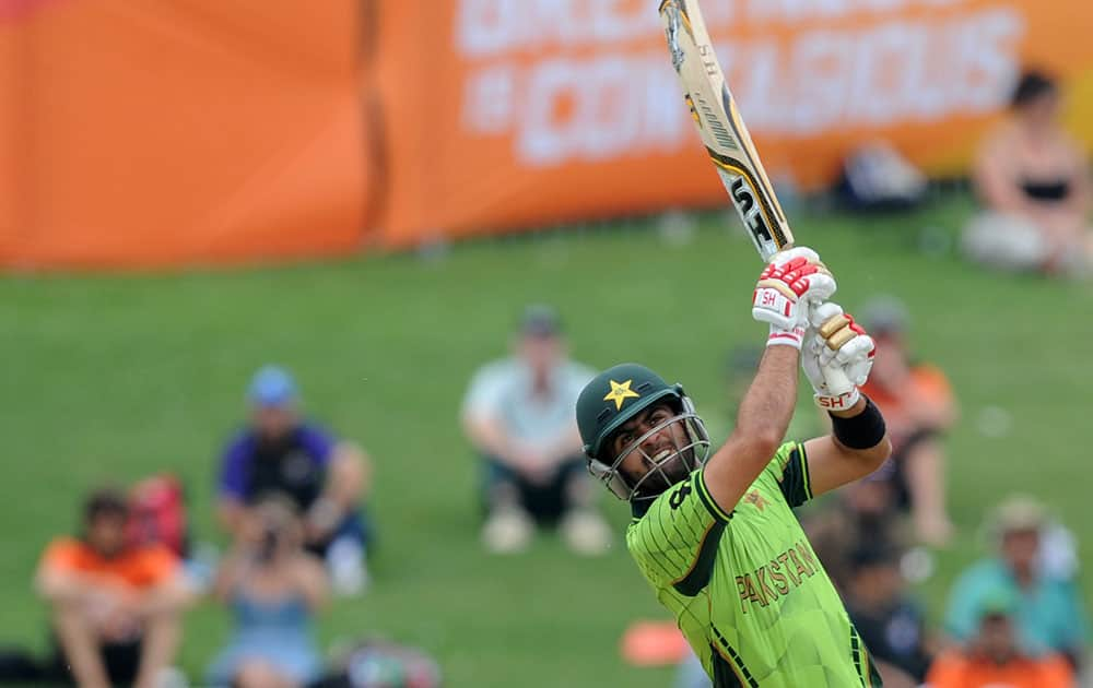 Pakistan's Ahmad Shahzad watches as he hits the ball to the boundary while batting against the United Arab Emirates during their Cricket World Cup Pool B match in Napier, New Zealand.