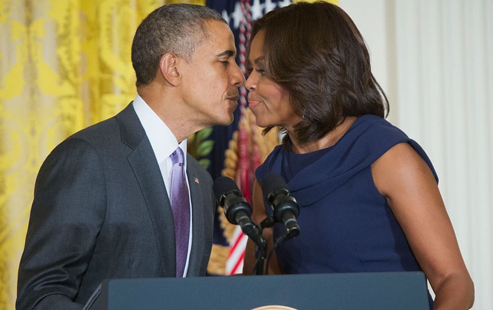 President Barack Obama kisses first lady Michelle Obama in the East Room of the White House in Washington, during te announcement of their 'Let Girls Learn' initiative. 