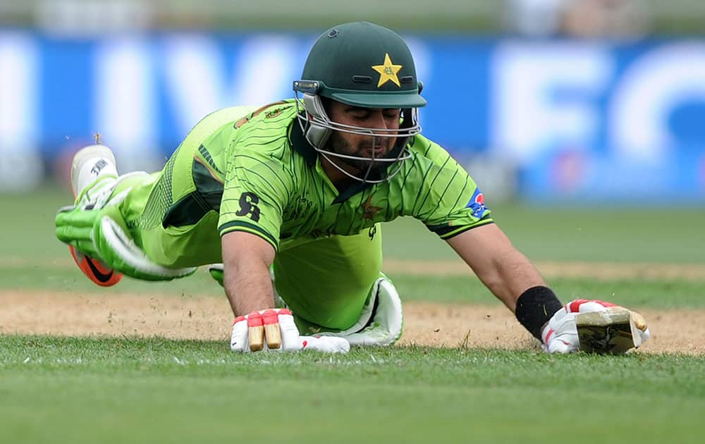 Pakistan's Ahmad Shahzad dives to make his ground unsuccessfully to be run out for 93 runs during their Cricket World Cup Pool B match against the United Arab Emirates in Napier, New Zealand.