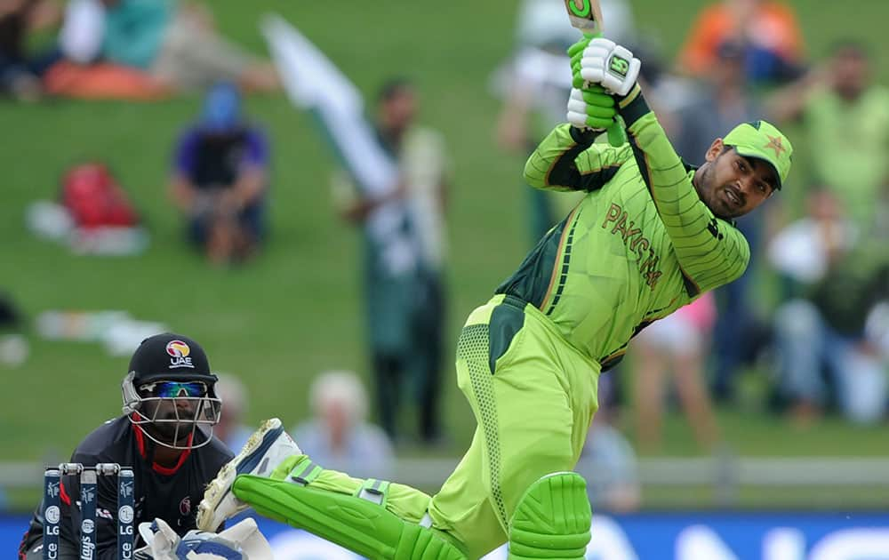 Pakistan's Haris Sohail hits the ball to the boundary as United Arab Emirates wicketkeeper Swapnil Patil watches during their Cricket World Cup Pool B match in Napier, New Zealand.