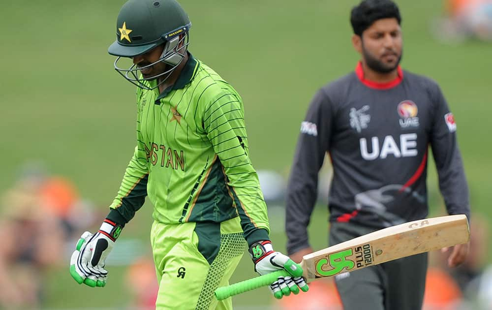 Pakistan's Haris Sohail walks from the field after he was dismissed by United Arab Emirates bowler Muhammad Naveed, right, during their Cricket World Cup Pool B match in Napier, New Zealand.