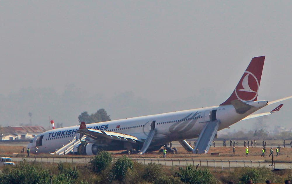 A Turkish Airlines jet is seen after it skidded off a slippery runway while landing in dense fog at Tribhuwan International Airport in Kathmandu, Nepal.The plane with 238 people on board was coming from Istanbul when the accident happened. Officials say passengers had bumps and bruises but no serious injuries.