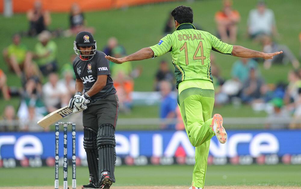 Pakistan bowler Sohail Khan, celebrates after taking the wicket of United Arab Emirates batsman Andri Raffaelo, left, during their Cricket World Cup Pool B match in Napier, New Zealand.