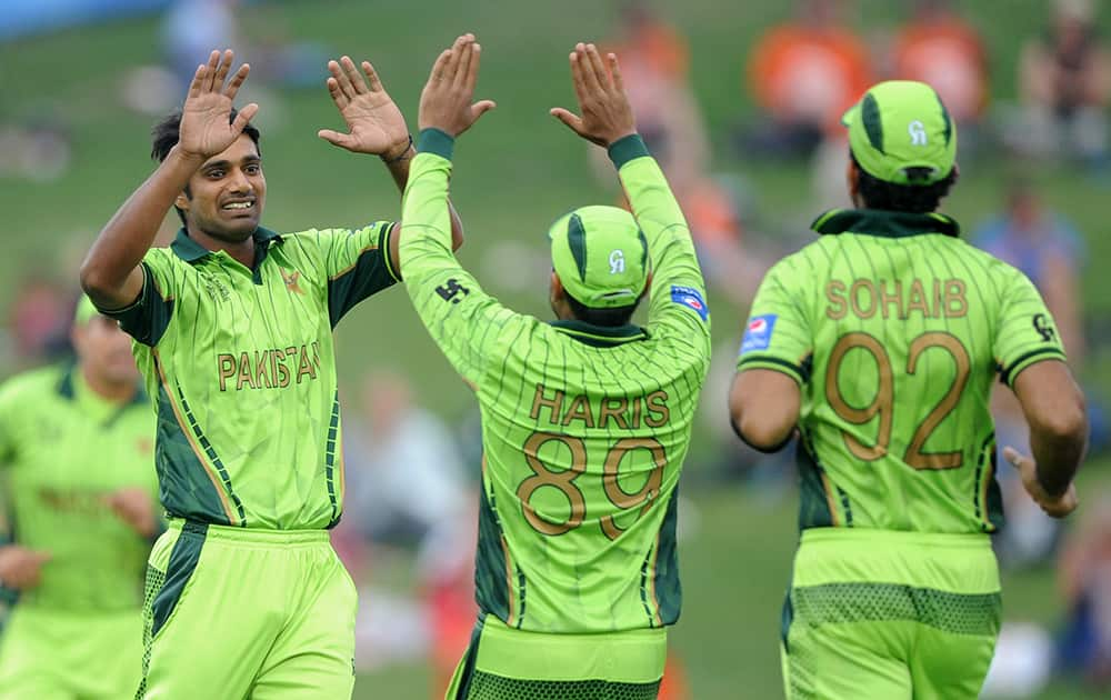 Pakistan's Rahat Ali, is congratulated by teammates Haris Sohail and Sohaib Maqsood, after dismissing United Arab Emirates batsman Amjad Ali during their Cricket World Cup Pool B match in Napier, New Zealand.