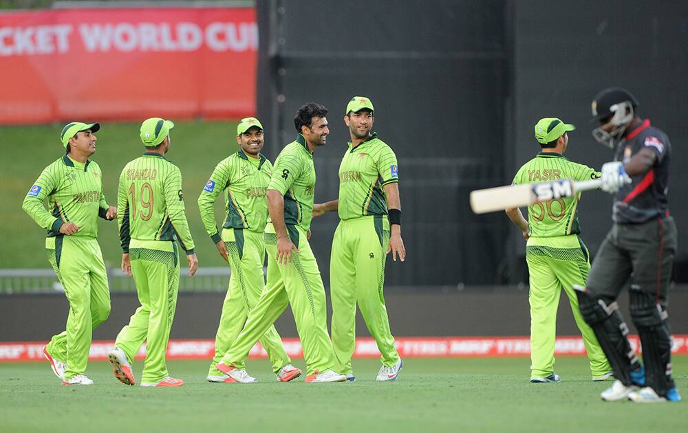 Pakistan bowler Sohail Khan, celebrates with teammates after taking the wicket of United Arab Emirates batsman K. Karate, during their Cricket World Cup Pool B match in Napier, New Zealand.