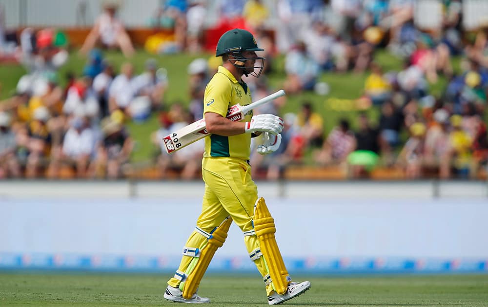 Australia's Aaron Finch walks back to the pavilion after being dismissed during their Cricket World Cup Pool A match against Afghanistan in Perth, Australia.