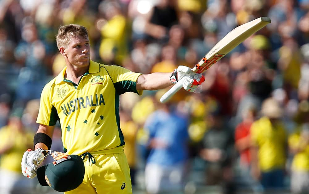 Australia's David Warner celebrates after scoring a century during their Cricket World Cup Pool A match against Afghanistan in Perth, Australia.